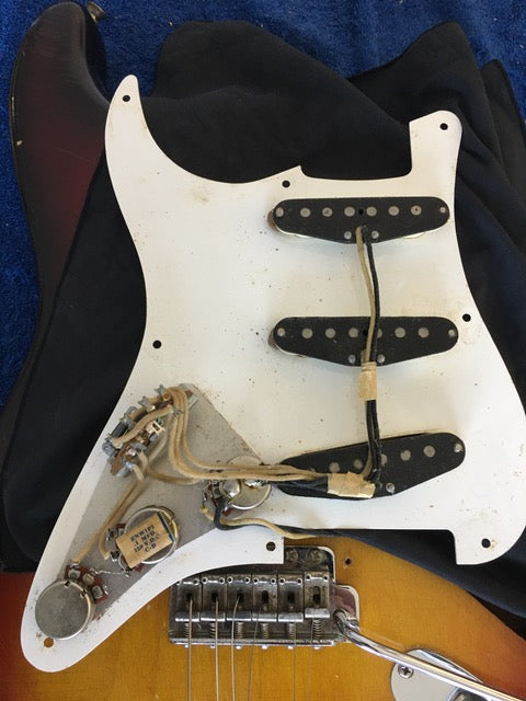 1958 USA Fender Stratocaster guitar, featuring a pickup and bridge, exemplifying vintage craftsmanship and style.