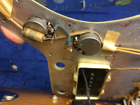 1960 Vintage Fender Jazzmaster guitar equipped with a pickup and wires, highlighting its iconic style and sound capabilities.