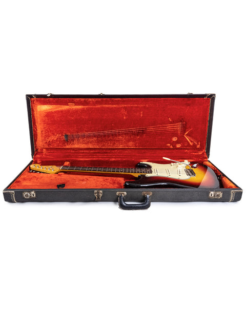 1964 Fender L Series Stratocaster in striking Fiesta Red, exemplifying vintage electric guitar artistry and American craftsmanship.