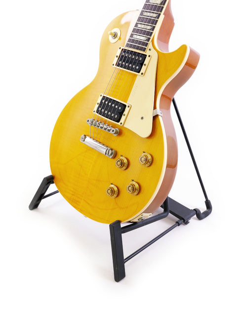 1991 USA Gibson Les Paul Standard guitar displayed on a stand, highlighting its iconic shape and vintage appeal.
