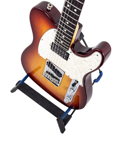 2002 Fender American Standard Telecaster guitar displayed on a stand featuring a stylish black base.