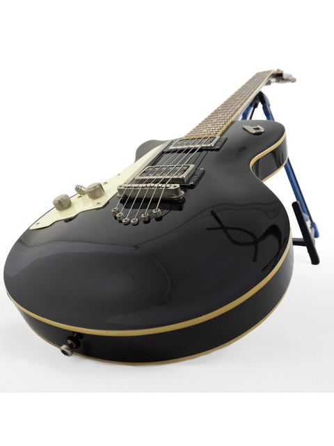 2014 Duesenberg 49er solid body electric guitar in black, elegantly displayed on a stand.