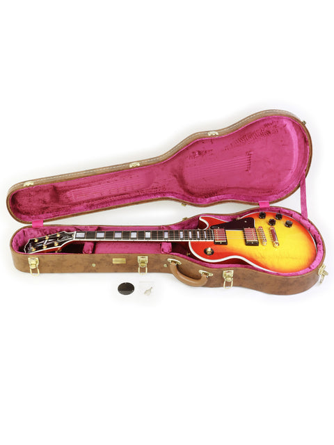 2014 Gibson Les Paul Custom guitar nestled in its case, highlighting its classic style and premium quality.