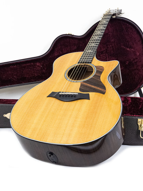 2016 Taylor 614ce grand acoustic guitar, featuring a beautiful finish and intricate details.