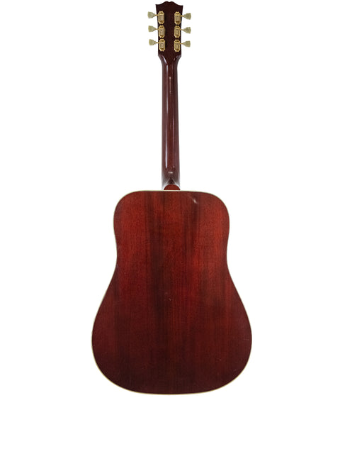 A 1955 Gibson D-28 dreadnought acoustic guitar, showcasing its vintage craftsmanship and rich wood tones.