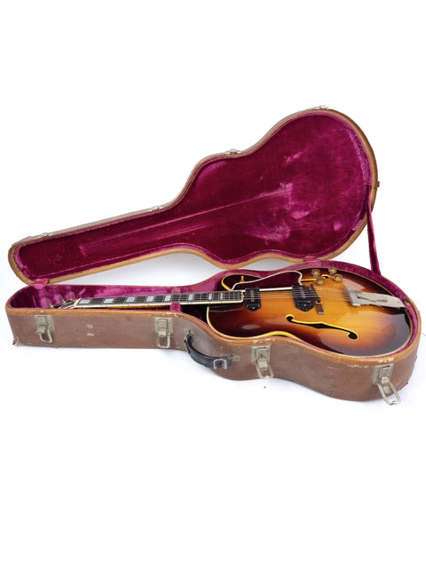 A 1955 Gibson L-5 CES guitar with Alnico pickups displayed in a case on a clean white background.