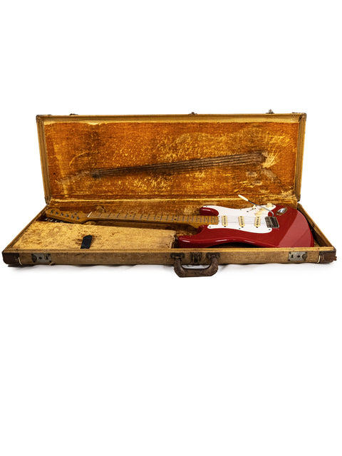 A 1957 Fender Stratocaster electric guitar, refinished in Dakota Red, exemplifying vintage American guitar artistry.