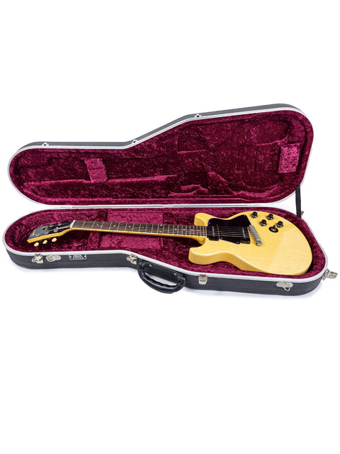 A 1958 Gibson Les Paul Special Double Cut guitar in its case, showcased on a stark white background.