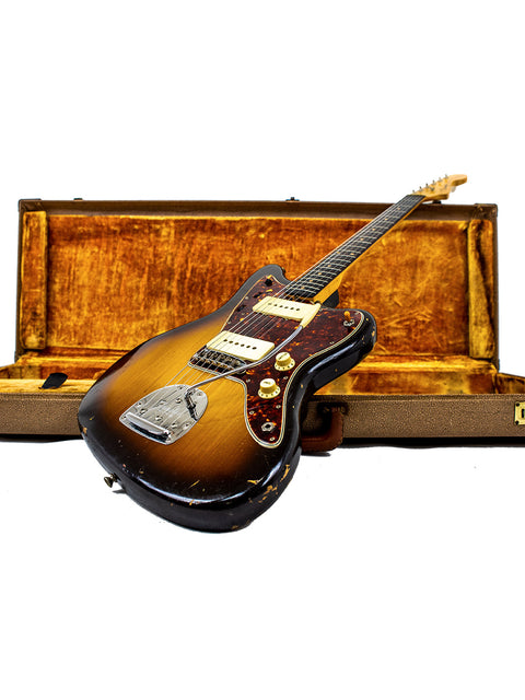 A 1960 vintage Fender Jazzmaster guitar securely housed in a wooden case, highlighting its timeless elegance and style.