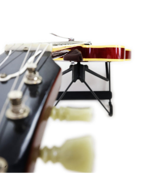 A 1963 Gibson ES-335 guitar atop a stand, highlighting its classic design.