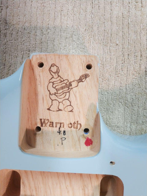 A 2012 USA Warmoth Strat Partscaster guitar, embellished with a captivating drawing of a man, perfect for music lovers.
