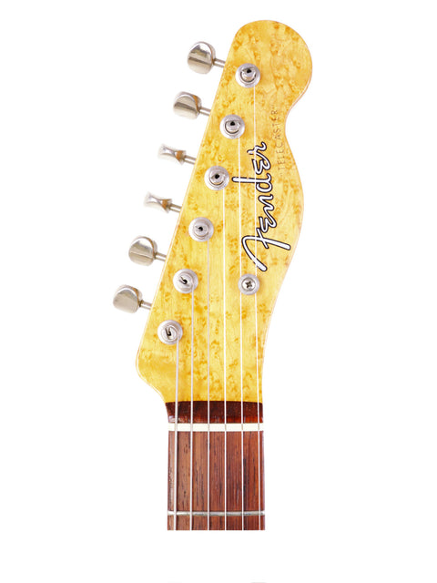 A Fender American Standard Stratocaster M-1, showcasing its sleek design and vibrant finish, alongside a 1998 Fender Custom Shop Telecaster.