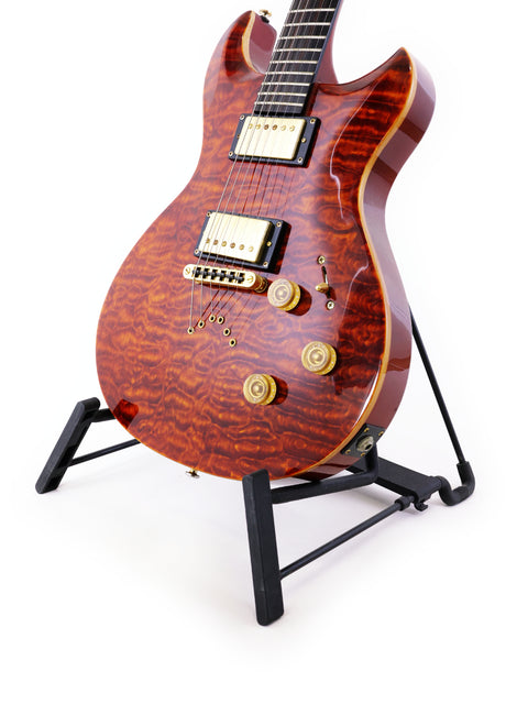 A Jarrett Forza guitar, Serial #00001, showcased on a stand with a simple white background, emphasizing its sleek design.