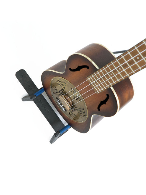A Kala KA-RES-BRS tenor resonator ukulele from 2019, topped with a guitar stand for display.