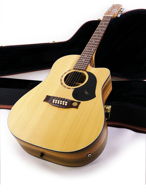 A Maton EM425C 12-string guitar from 2009 displayed in its case on a white surface.