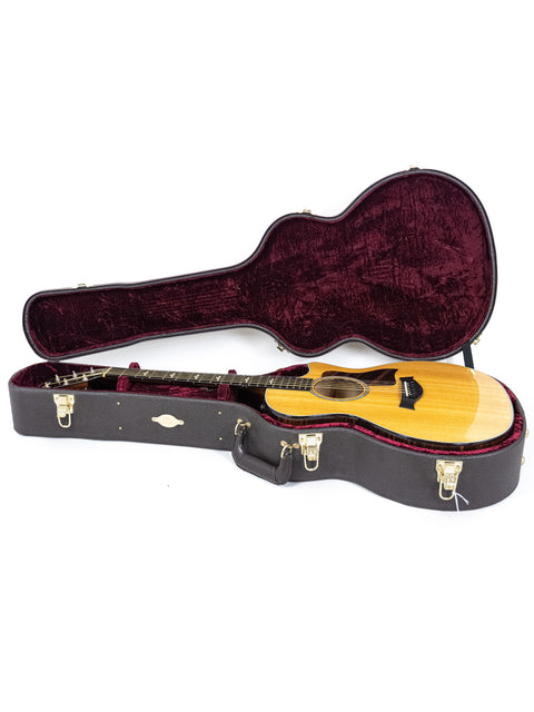 A Taylor 614ce guitar nestled in a wooden case, highlighting its beauty and quality from the USA, made in 2016.