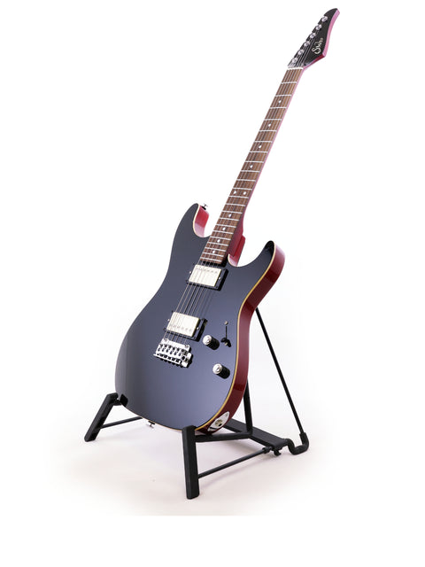 A USA-made Suhr Pete Thorn Signature guitar rests on a stand, featuring a minimalist white background for emphasis.