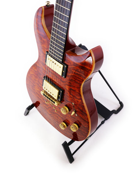 A beautifully crafted wooden guitar on a stand, marked Jarrett Forza, Serial #00001, from the USA, made in 2007.