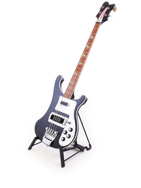 A black Rickenbacker 4003 Jetglo bass guitar on a stand, set against a bright white background.