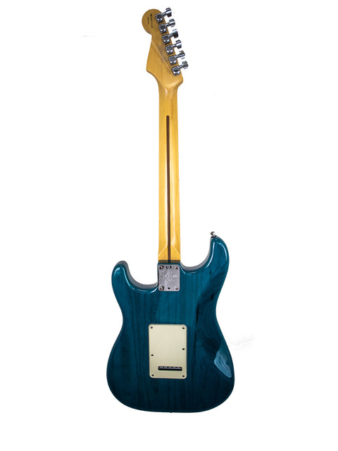 A blue electric guitar with a wooden body, showcasing the Fender American Deluxe Stratocaster from 2004, USA-made.