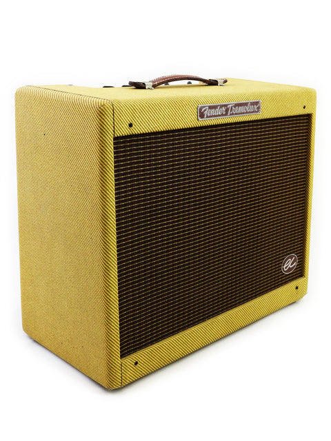 A bright yellow Fender EC Tremolux Combo Amplifier (2014) displayed on a white background, highlighting its unique design.