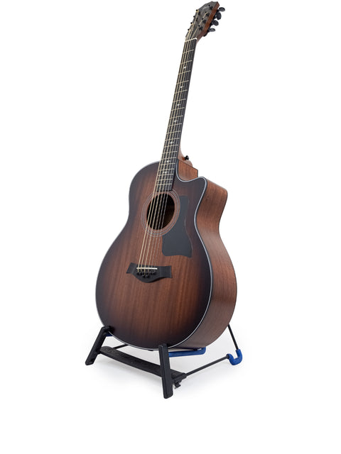 A brown acoustic guitar, the Taylor 326 CE Baritone 8 LTD from 2020, elegantly positioned on a stand.
