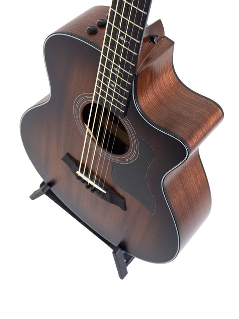 A brown acoustic guitar, the Taylor 326 CE Baritone 8 LTD from 2020, elegantly positioned on a stand for display.