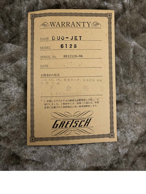 A brown label marked "warrant," connected to the 1989 Gretsch Duo Jet 6128 guitar from Japan.