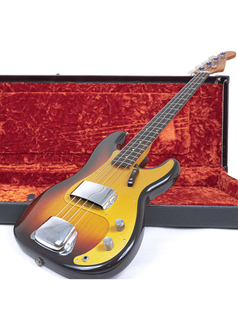 A classic 1958/59 Fender Precision Bass guitar displayed in its protective case, highlighting its vintage appeal and craftsmanship.