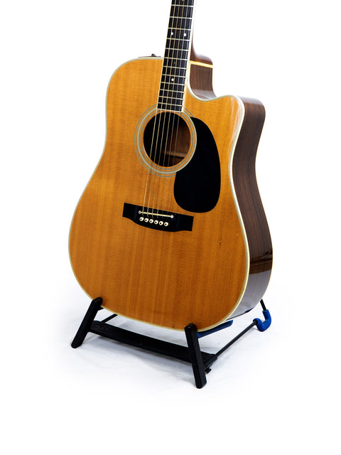 A classic 1988 Takamine EF 360SC guitar on a stand, set against a simple white background.