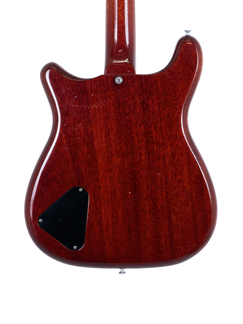 A classic red Epiphone Coronet guitar from 1965, highlighted by its contrasting black pickguard, perfect for music lovers.