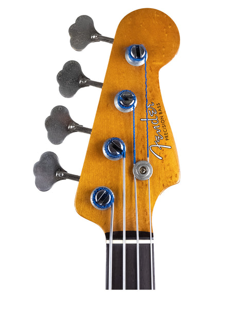 A close-up of a 1958/59 Fender Precision Bass guitar, featuring its vintage details on a stark white background.