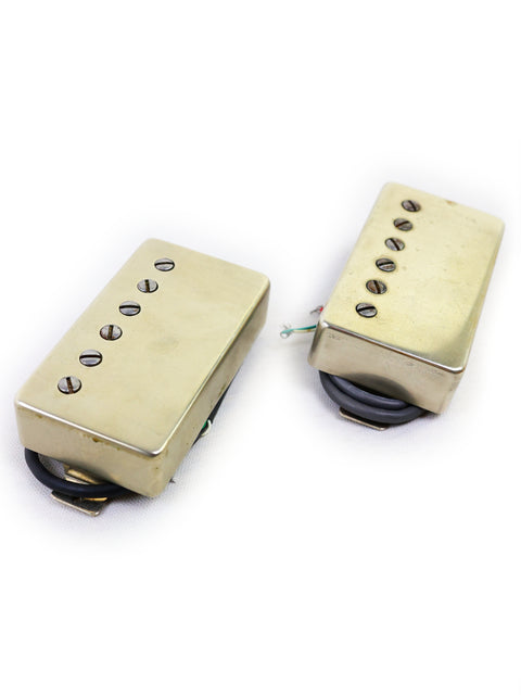 A pair of gold-covered humbuckers displayed on a white background, featuring the Tom Holmes H450/H455 Pickups Set.