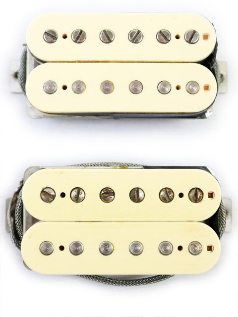 A pair of humbuckers with white covers and black knobs, labeled as Peter Florance Voodoo Humbucker ’59/‘57 from 2005.
