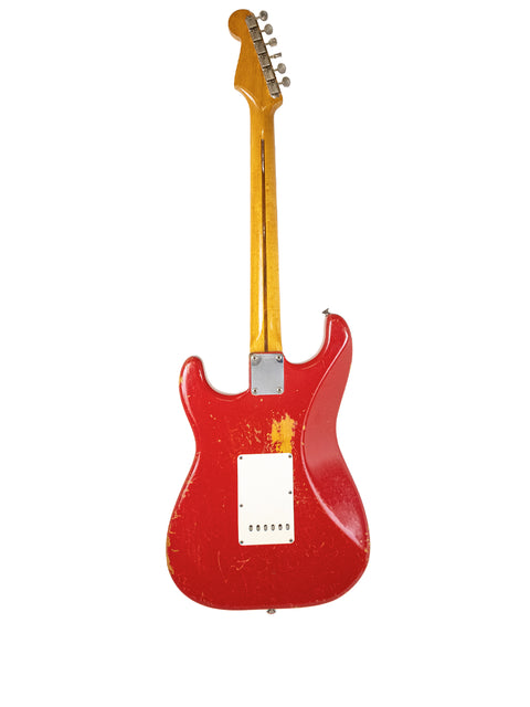A red 1957 Fender Stratocaster, refinished in Dakota Red, presented on a white background, illustrating its timeless design.