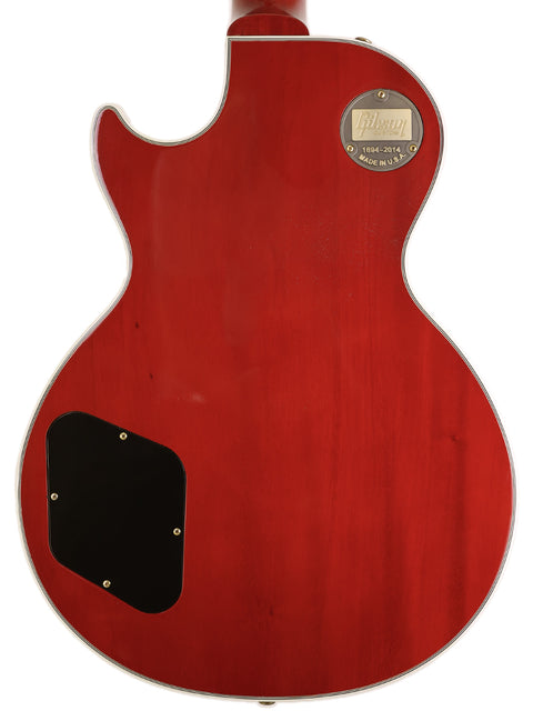 A red Gibson Custom Shop Les Paul Custom electric guitar with a sleek black pickguard, showcasing its vibrant color and design.