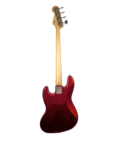 A red electric guitar against a white background, showcasing the Fender Custom Shop ‘62 Jazz Bass Reissue from 2001.