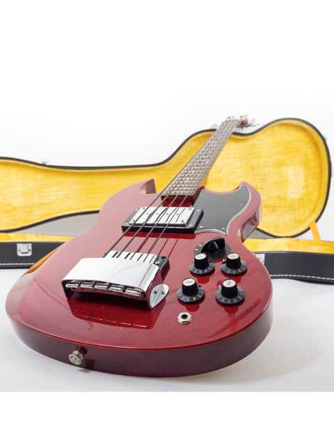 A red electric guitar and its case, highlighting the Ibanez 2403B Lawsuit Bass, EB-3 style, crafted in Japan, 1976.