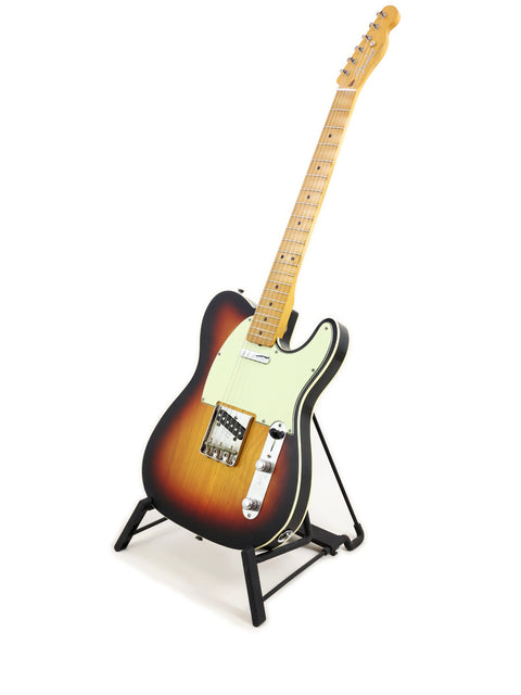 A sleek Txxx Custom Style Partscaster guitar in matte sunburst, displayed on a stand with a bright white backdrop.