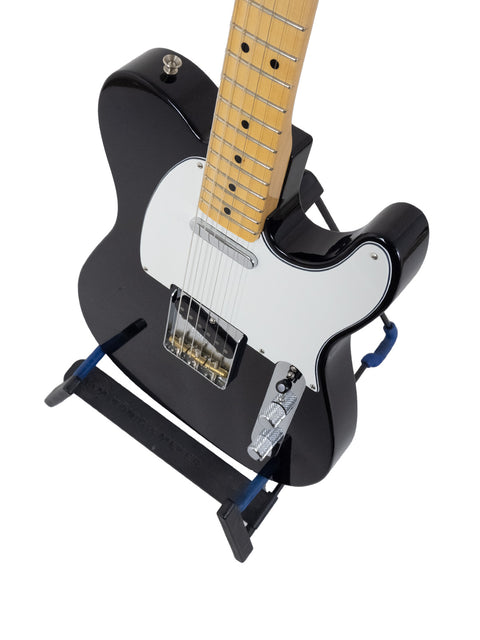 A sleek black guitar with a striking blue pick guard, representing the 2017 Fender Custom Shop 30th Anniversary ’51 Nocaster.