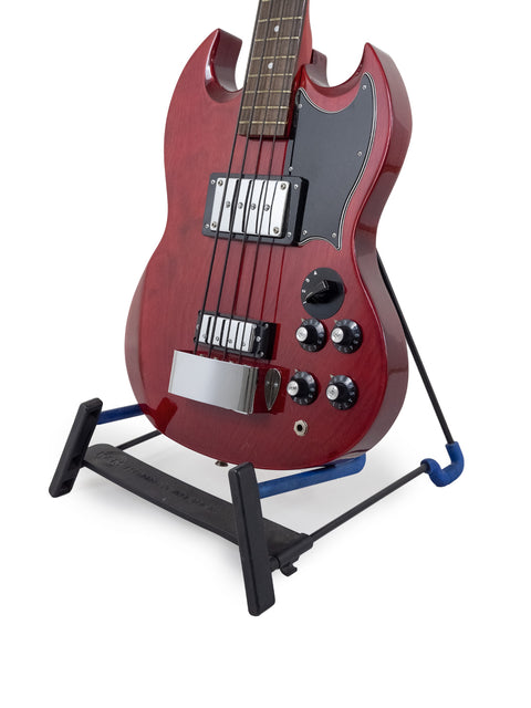 A striking red electric guitar displayed on a stand, highlighting its eye-catching appearance and craftsmanship.