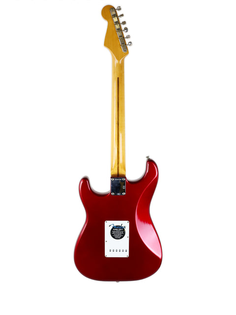A striking red electric guitar, the Fender Vintage Hot Rod ‘57 Stratocaster, set on a bright white backdrop.