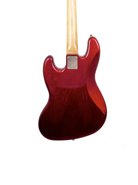 A striking red guitar with a wooden body and neck, identified as the Fender Custom Shop ‘62 Jazz Bass Reissue from 2001.