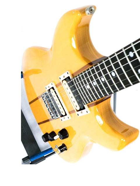A striking yellow electric guitar displayed on a blue stand, representing the Aria Pro II TS 400 Tri Sound Series, Japan 1980.