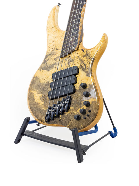 A stunning Dingwall Z3 Buckeye Custom 5 String Bass guitar on a stand, highlighted by a simple white background for clarity.