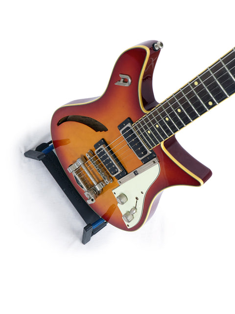 A stunning Duesenberg Double Cat guitar featuring a sunburst finish, set on a pristine white backdrop.