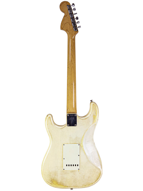 A stunning white 1968 Fender Stratocaster with a wooden body and neck, embodying timeless style and vintage appeal.