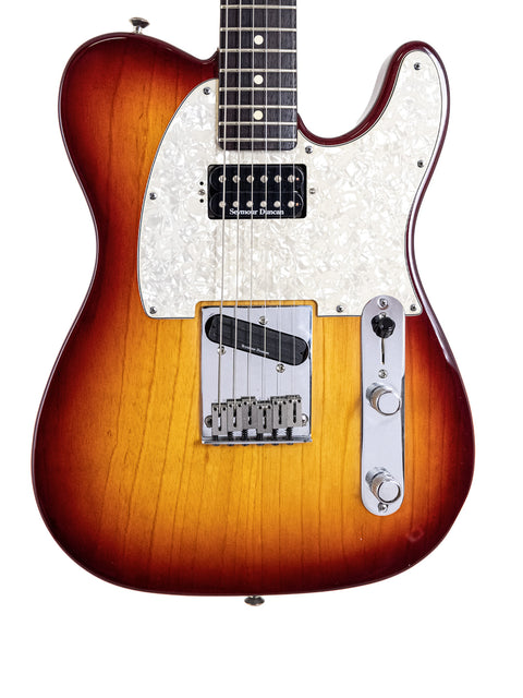 A sunburst-finished Fender American Standard Telecaster guitar from 2002, featuring Duncan pickups, showcasing its vibrant colors.