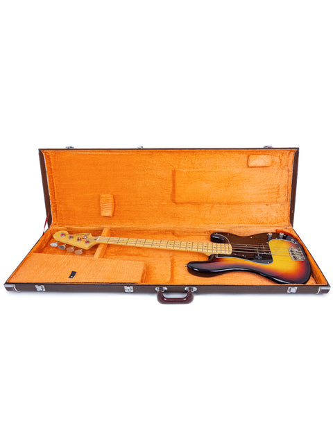 A vibrant orange guitar case containing a Fernandes P Bass guitar, made in Japan between 1978 and 1981.