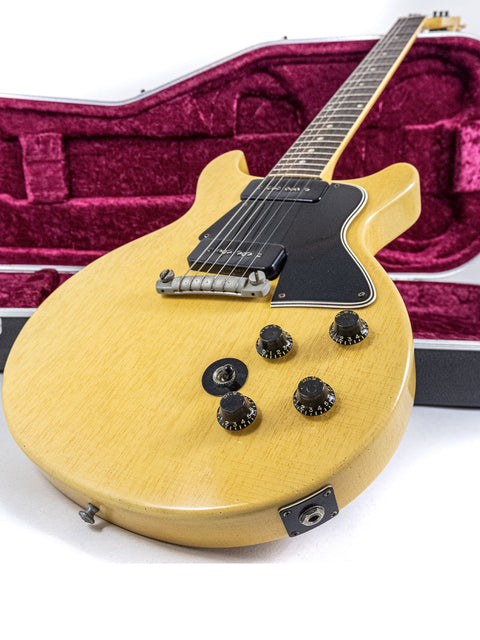A vintage 1958 Gibson Les Paul Special, finished in yellow, resting securely in its case.